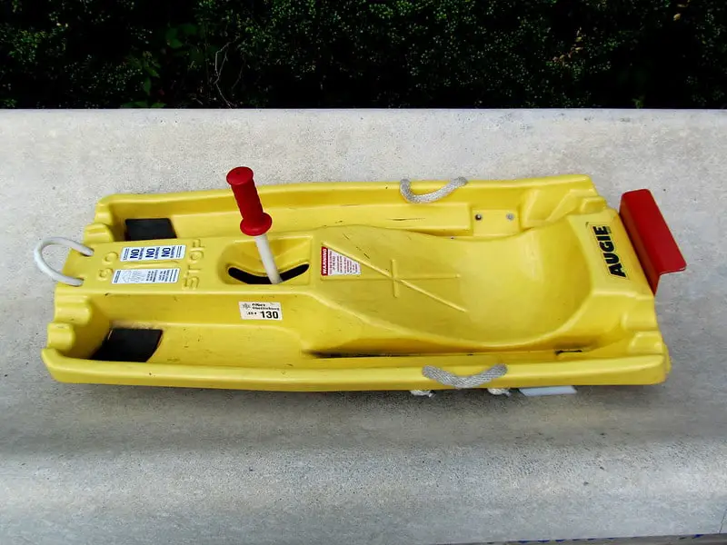 Yellow alpine slide cart with red brake lever